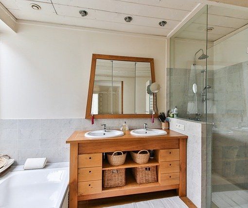 dual sink bathroom with tub and shower