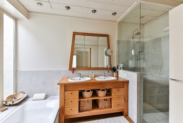 dual sink bathroom with tub and shower